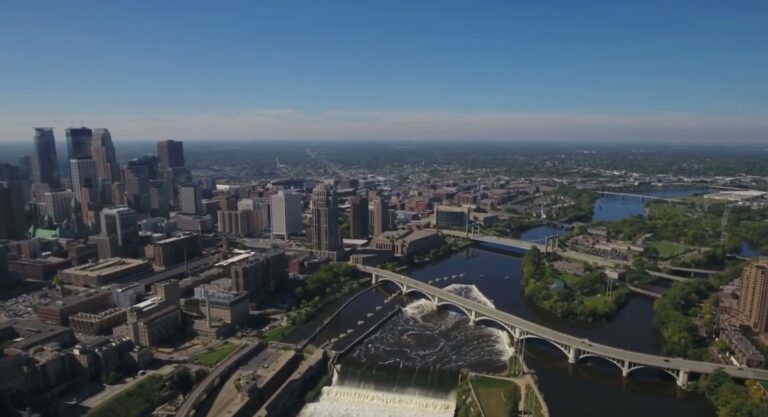 Aerial view of a cityscape with skyscrapers and bridges over a river