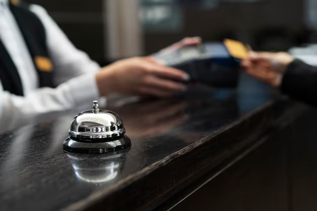 A bell on the reception desk with the administrator in the background